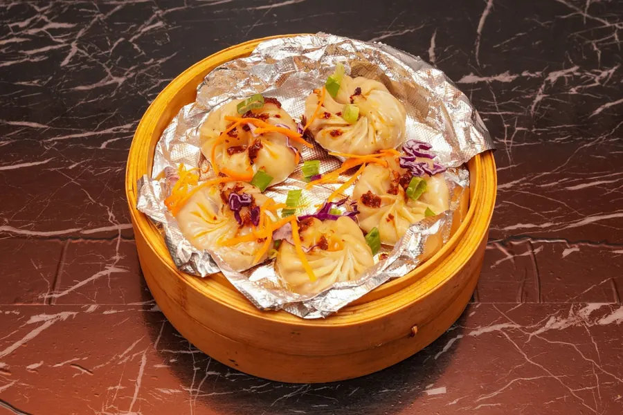 Steamed momo in bamboo basket